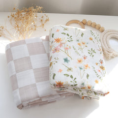 LifeTree Muslin Swaddle Blanket with baby in arms; secure swaddle for peaceful naps