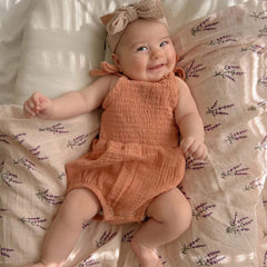 LifeTree organic cotton muslin swaddle offers gentle softness.