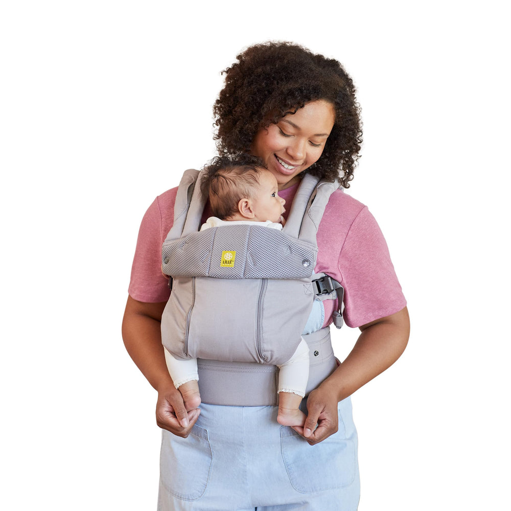 LÍLLÉbaby Complete All Seasons carrier demonstrates 6-position versatility for front, hip, and back carrying