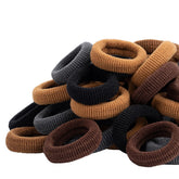 Lintopos baby hair ties 100-pack brown close-up showing soft, gentle stretch for daily wear.
