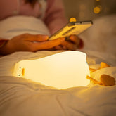 Liqmin Duck Night Light on bedside with warm, comforting glow for late-night feeds