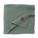Little Dedi Alina blanket green folded for quick snuggles and compact nursery storage.