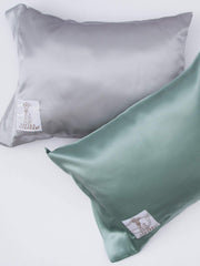 Little Giraffe satin-trim pillow closeup showing smooth border and soft knit texture