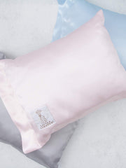 Little Giraffe Satin Decor Pillow 10x13 on bed shows compact, cozy support.