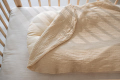 Little Jump organic-cotton muslin fabric detail for breathable, gentle skin-friendly touch.
