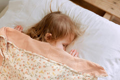 Little Jump muslin blanket peach floral folded highlights versatile coverage for tummy time and stroller trips.