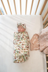 Little Jump Western Wild Flowers pattern on a swaddle for stylish nursery photos.