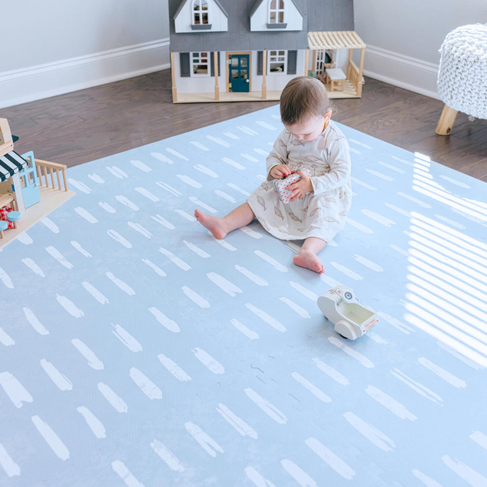 Little Landings Shoreline 6x6ft play mat provides a soft, cushioned surface for tummy time.