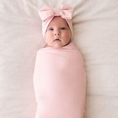 Little Sleepies swaddle Prima Pink used as nursing wrap for on-the-go feeding