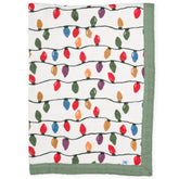 Little Unicorn Christmas Bulbs quilt—soft 4-layer muslin blanket for cozy naps.