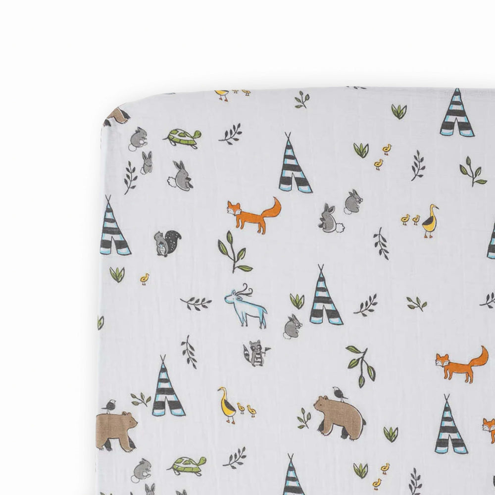 Little Unicorn Forest Friends crib sheet folded showing premium muslin softness for easy setup.