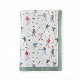 Little Unicorn Deluxe Muslin Quilt baby snuggle close-up showing silky-soft bamboo rayon.