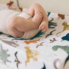 Little Unicorn Dino Friends changing pad cover safety holes accommodate straps on standard pads.