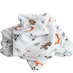 Little Unicorn Forest Friends swaddle on floor during playtime for comfort