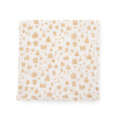 Little Unicorn Gingerbread Village stroller cover illustrates portable blanket for on-the-go comfort.