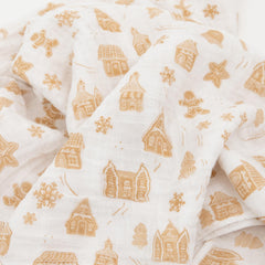 Little Unicorn Gingerbread Village swaddle on baby demonstrates soft, secure wrap for soothing routines.