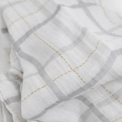 Little Unicorn nursing moment β swaddle doubles as a light nursing cover.