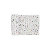 Little Unicorn premium cotton swaddle closeup on soft muslin texture for gentle baby comfort.