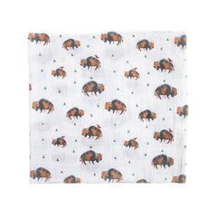 Little Unicorn swaddle blanket on floor during playtime in cozy nursery.