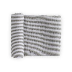 Little Unicorn premium cotton swaddle in grey stripe folded for travel and storage