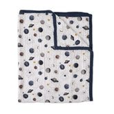 Little Unicorn Premium Quilted Throw Planetary folded, showing compact travel warmth for on-the-go families