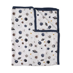 Little Unicorn Premium Quilted Throw Planetary folded, showing compact travel warmth for on-the-go families