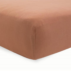 Little Unicorn terracotta stretch knit crib sheet close-up highlighting soft fabric