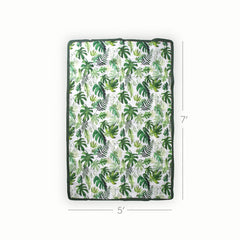 Little Unicorn tropical leaf blanket over the shoulder for hands-free picnics