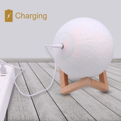 LOGROTATE moon lamp charging cable in use on desk providing ambient lighting