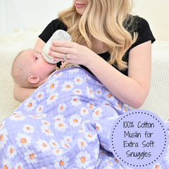 LollyBanks Muslin Baby Blanket in nursery scene highlights bright daisy print and cozy warmth.