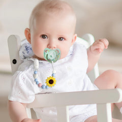 LSTRAGY pacifier clips two-pack shown in baby's hands for easy access
