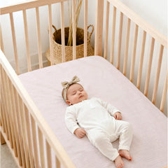 Lulu Moon muslin crib sheets breathable material close-up for temperature comfort.