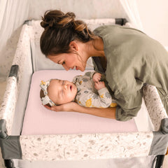 lulumoon pink-tone pack and play sheets brighten the nursery for a gentle girls' room.