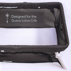 Luvberries Guava Lotus sheets on travel crib mattress provide secure fit and gentle comfort.