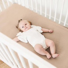 MairMore Muslin crib sheets in neutral ash and ivory complement nursery decor.