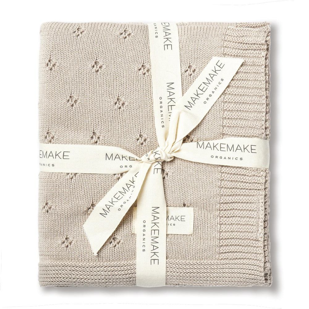 MakeMake Organics baby blanket beige-knit close-up highlights ultra-soft organic cotton for sensitive skin.