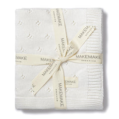 Makemake Organics pointelle-knit closeup: breathable texture and delicate drape for everyday comfort.