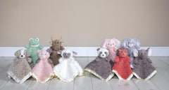 Mary Meyer Putty Nursery Piglet satin lining visible on blanket edge.