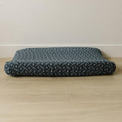 Mebie Baby Navy Berry changing pad cover on a changing table, breathable muslin for baby's comfort.