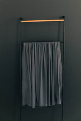 Mebie Baby Charcoal Stretch Swaddle on baby demonstrates a secure, cozy wrap.