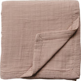 Mebie Baby muslin quilt folded in dusty rose for snuggly warmth and easy layering.