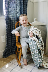 Mebie Baby muslin quilt close-up showing four-layer fabric for durability.