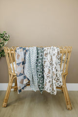 Mebie Baby Outlaw Cowboy Swaddle in crib demonstrates a lightweight blanket option for older babies.