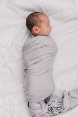 Mebie Baby Stone Swaddle baby-wrapped view demonstrates secure wrap and cozy cuddles.
