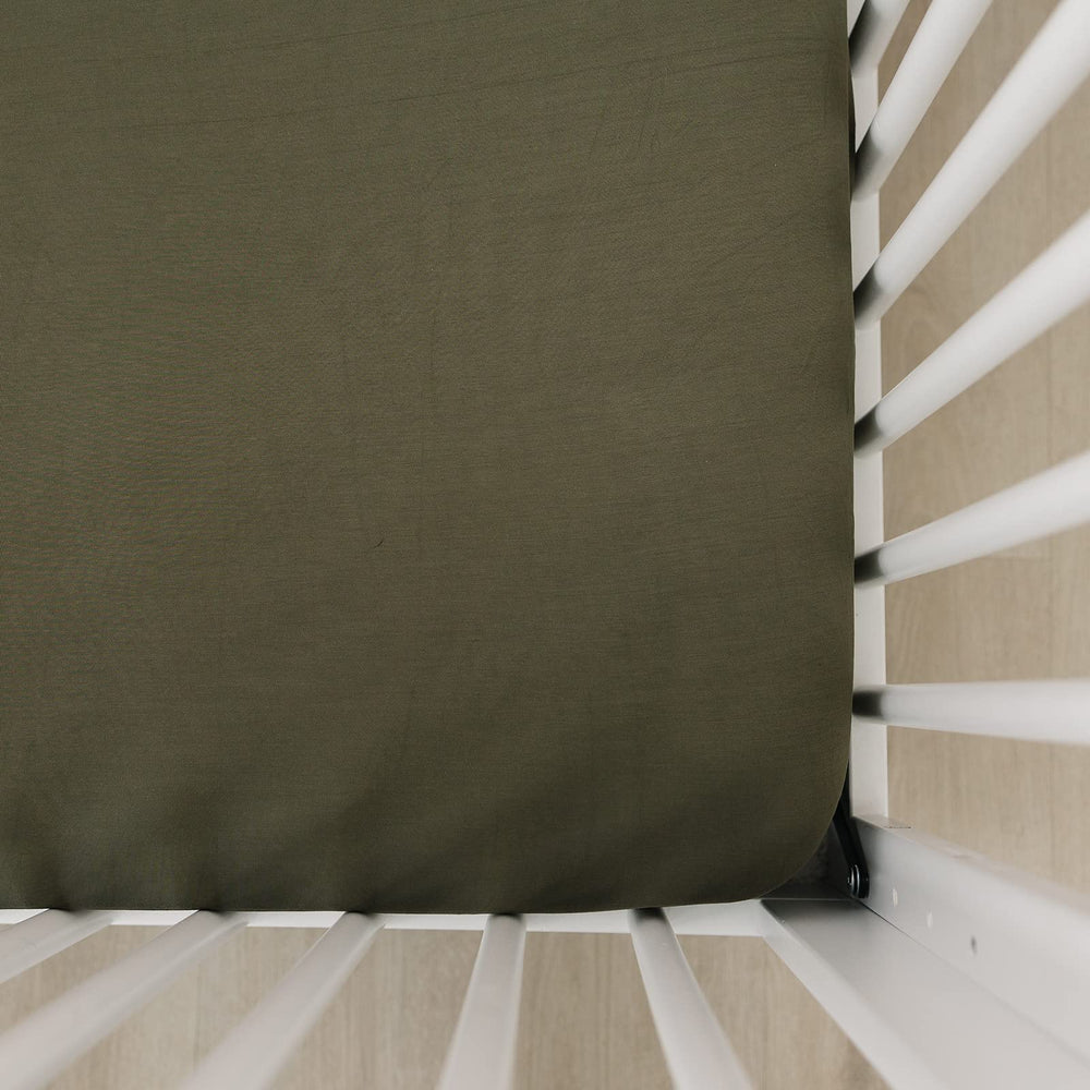 Mebie Baby Stretch Sheet Olive closeup showcases soft bamboo-blend fabric for cozy crib comfort.