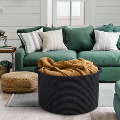 MEGASKET blanket basket with decorative pillows complements bedroom decor.