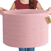 MEGASKET Extra Large Pink Basket front view shows ample blanket storage in a cozy living room.