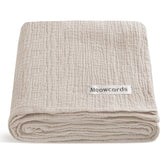 Meowcards Muslin Swaddle Blanket close-up shows ultra-soft double muslin texture for newborn comfort.