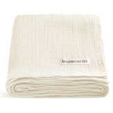 Meowcards muslin swaddle pale yellow folded for easy storage and quick setup