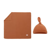 Miracle Baby swaddle blanket and hat set laid flat, cozy, breathable for newborn comfort.